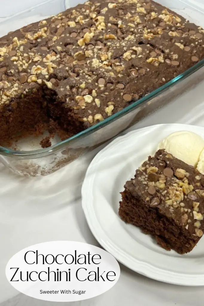 Indulge in the rich, moist goodness of this Chocolate Zucchini Cake recipe! Made with fresh zucchini and cocoa, this decadent cake is perfectly fudgy while sneaking in a healthy twist. Topped with chopped walnuts for pecans and chocolate chips. It's an easy dessert that's perfect for family gatherings, potlucks, or anytime chocolate cravings strike. #ChocolateZucchiniCake #MoistChocolateCake #EasyDesserts #HiddenVeggies #HealthyTwist #ZucchiniRecipes #DecadentDesserts