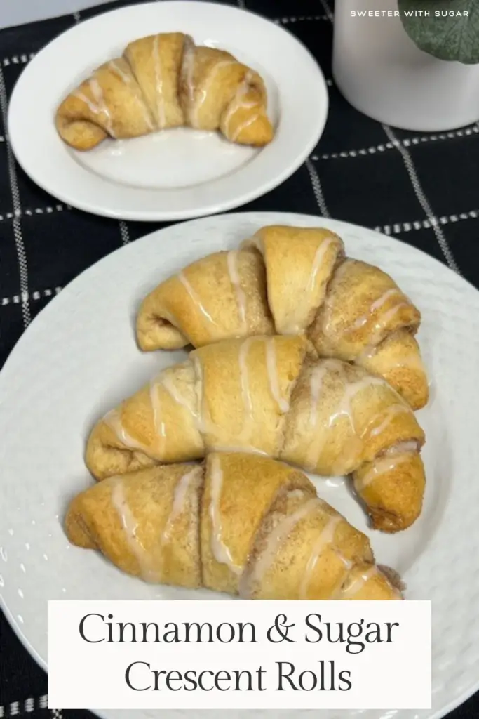 A plate of golden brown cinnamon sugar crescent rolls, filled with a buttery cinnamon and sugar filling and with a drizzle of vanilla glaze on top.
#CinnamonSugarCrescentRolls #EasyBaking #CrescentRollRecipes #MiniCinnamonRolls #SweetBreakfast #HomemadeTreats #SimpleDesserts